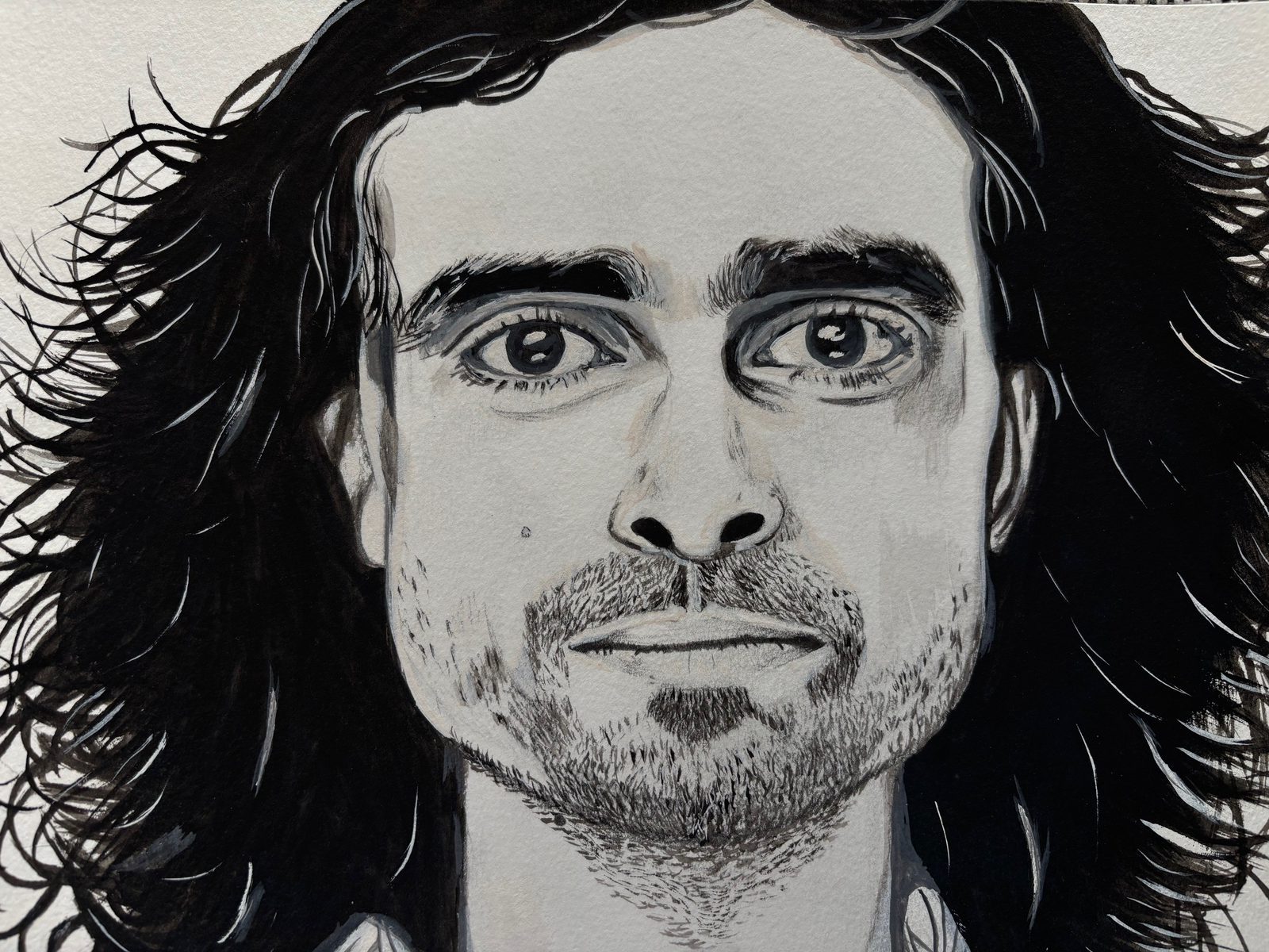 Black and white portrait of a man with steady eyes and flowing dark hair